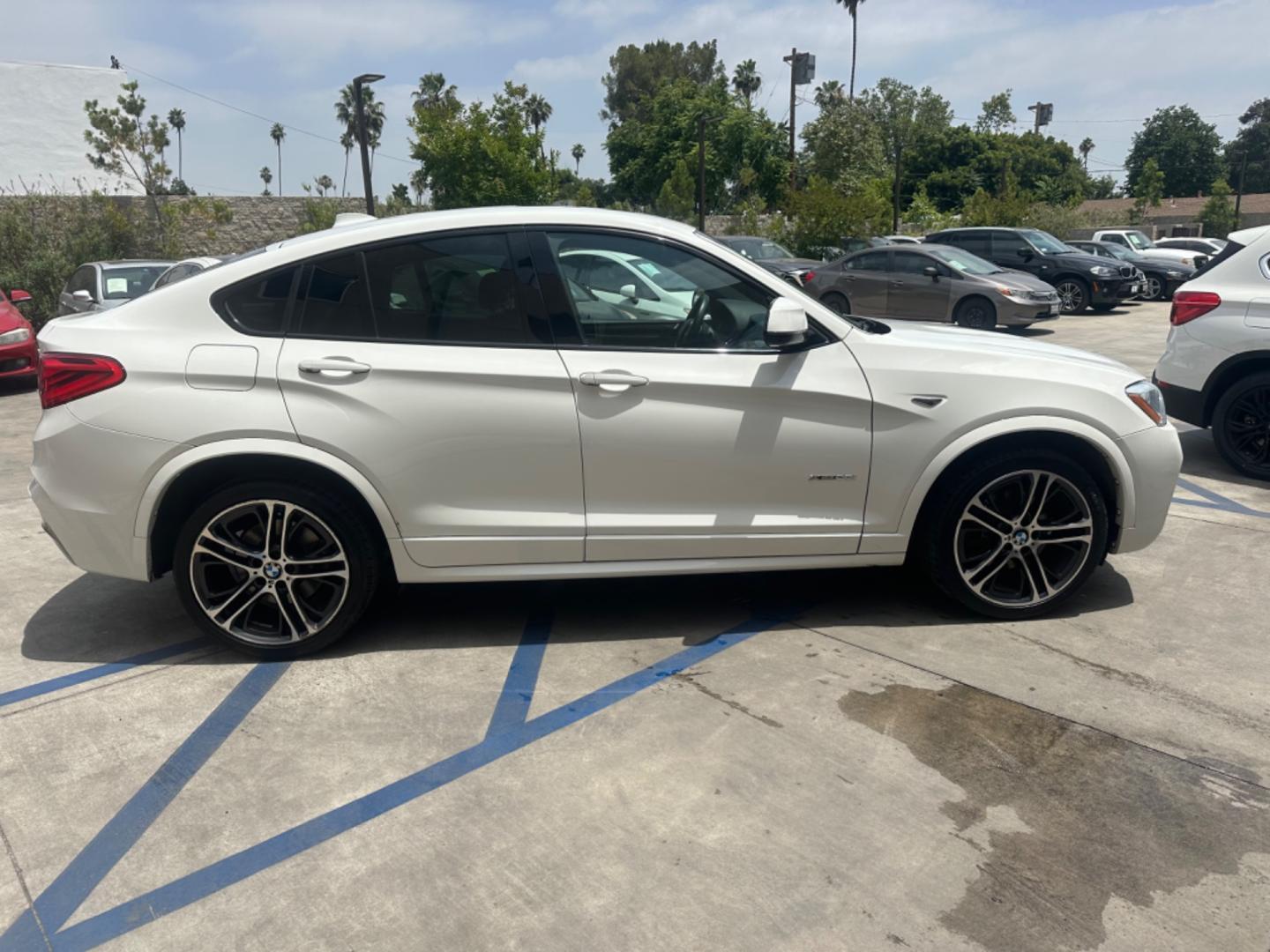 2015 Alpine White /Black BMW X4 Leather (5UXXW3C59F0) with an 2.0 engine, Automatic transmission, located at 30 S. Berkeley Avenue, Pasadena, CA, 91107, (626) 248-7567, 34.145447, -118.109398 - Discover the 2015 BMW X4 xDrive28i: Luxury Meets Affordability Are you in the market for a luxury vehicle that doesn't break the bank? Look no further than the 2015 BMW X4 xDrive28i. This impressive model offers the perfect blend of performance, style, and affordability. At our dealership, we under - Photo#6