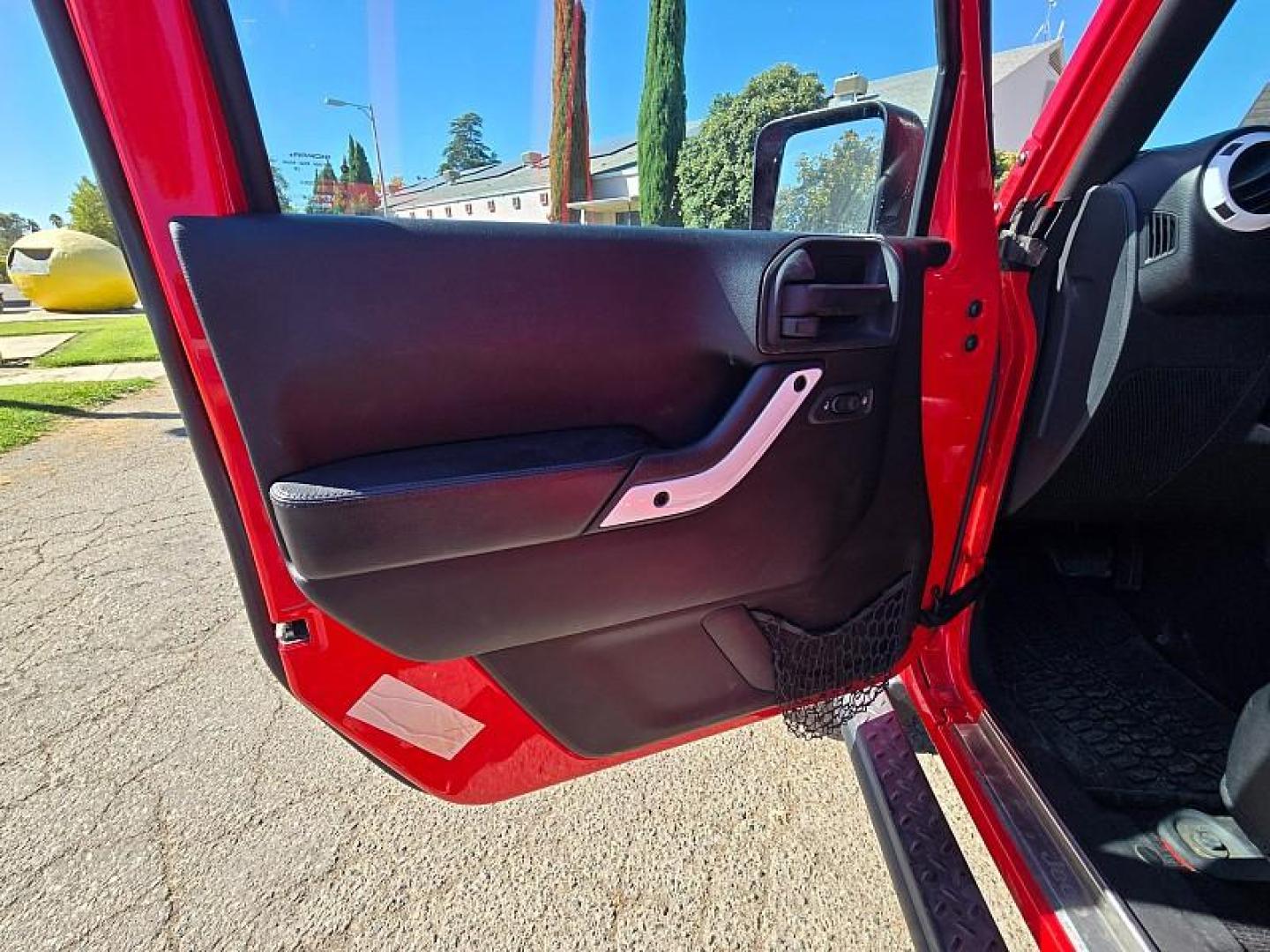 2015 RED Jeep Wrangler Unlimited (1C4BJWEG3FL) with an V6 3.6 Liter engine, Automatic 5-Spd transmission, located at 246 E Walker St., Orland, 95963, (530) 865-5800, 39.747589, -122.178398 - Photo#11