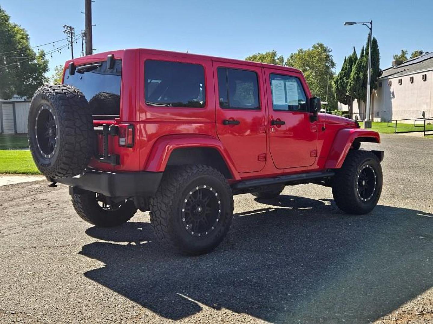 2015 RED Jeep Wrangler Unlimited (1C4BJWEG3FL) with an V6 3.6 Liter engine, Automatic 5-Spd transmission, located at 246 E Walker St., Orland, 95963, (530) 865-5800, 39.747589, -122.178398 - Photo#6